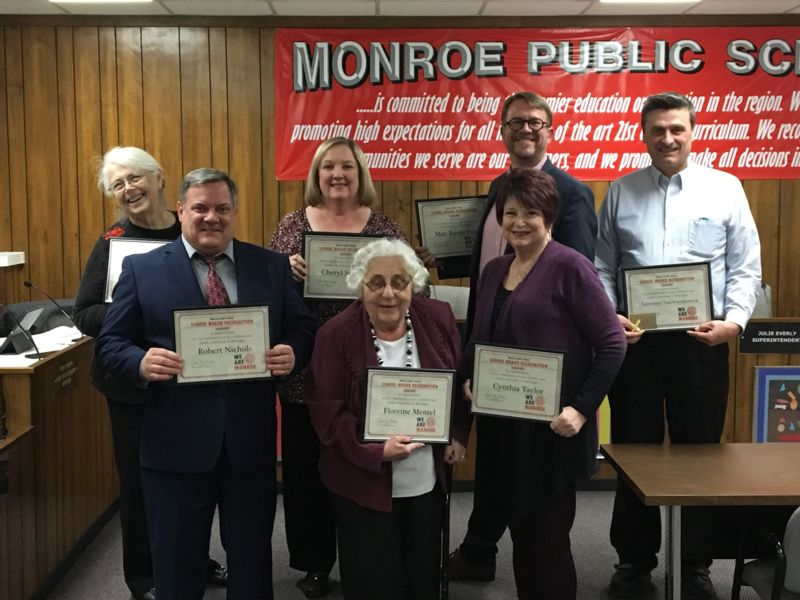 Monroe Public Schools Board of Education poses with certificates of recognition